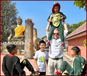 Karl Bruns-Kyler holding cute kids in Vietnam