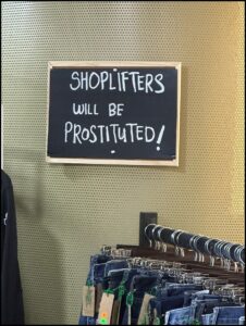 Shoplifters will be prostituted sign in a store.