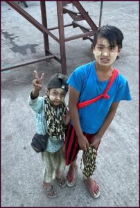 Two boys with makeup on made from Thanaka tree in Burma.
