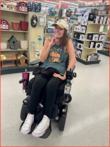 Ashleigh sitting in a wheelchair in Colorado.
