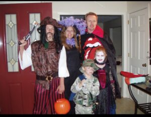 The family dressed up in costumes for Halloween.