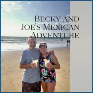 Becky and Joe each holding cold drinks on a beach in Mexico.