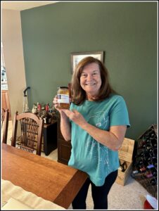 Colorado client of The Big 65 holding a jar of fresh honey from Karl Bruns-Kyler of The Big 65 Medicare Insurance Services.