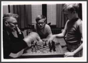 Karls dad playing chess with his sons.