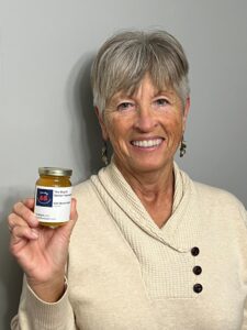 Darlene holding a jar of honey from The Big 65.