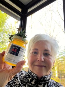 Rosemary holding a jar of honey from The Big 65.