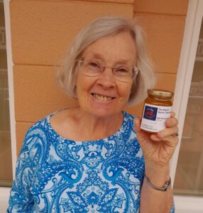 Judith holding a jar of honey from The Big 65.