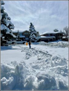 Quantz shoveling snow in Colorado for The Big 65.