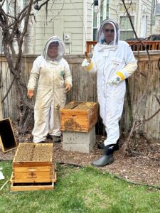 Shava and Karl working on the bee hives.