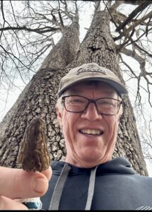 Haas in the Shenandoah Valley holding a Morel mushroom.
