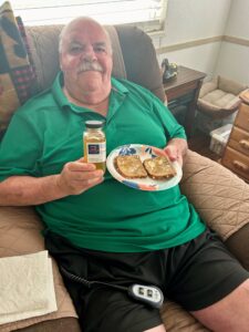 Mike in North Carolina holding sweet honey from The Big 65 Medicare Insurance broker.