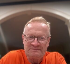 Dr. Kyler wearing an orange shirt.