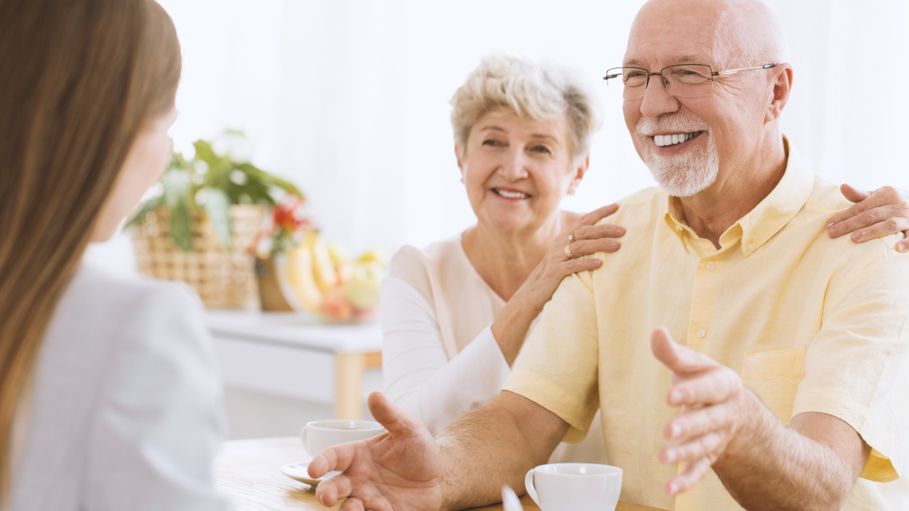 Two elderly person talking to an insurance broker