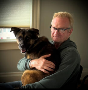 Karl's brother Robert holding Teddy the rescue dog.