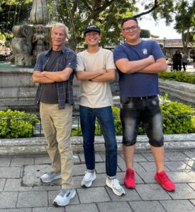 Three men with arms crossed posing for the camera.
