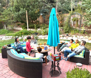 A group of people relaxing in a backyard.