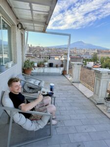 Nicholas sitting in a chair on a patio.