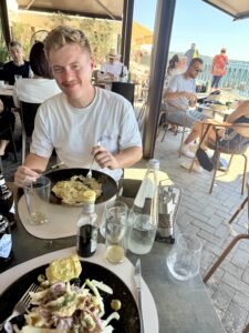 Nicholas eating from a plate.