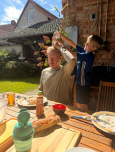 Gustave pouring water on Karl's head.