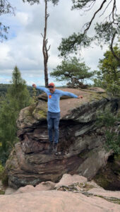 A man standing on a large rock.