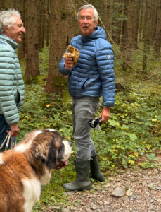 Rene and Boris and a St. Bernard dog in the woods.