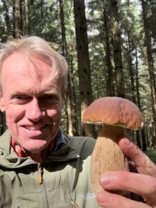 Karl holding a large mushroom.