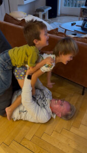 Karl holding two kids up in the air.