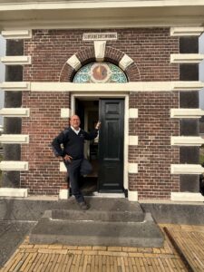 A man standing in front of a building.