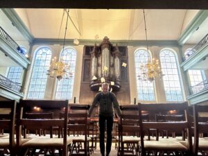 Karl standing in the worship house his mother used to worship in.