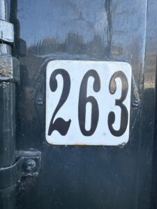 A white sign displaying the numbers 263.