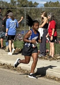 Miti running as part of her cross country team.
