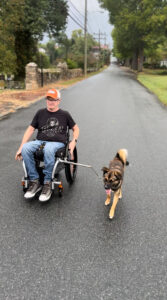 Rob on a street with his dog.