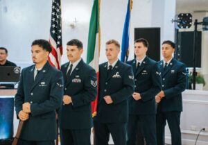 Nicholas in full Air Force uniform holding the Italian flag.