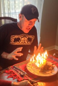 Karl blowing out the candles on his 65 birthday cake.