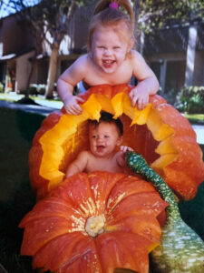 Cute kids in a pumpkin.