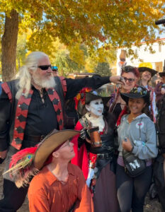 A group of people surrounding Miti.