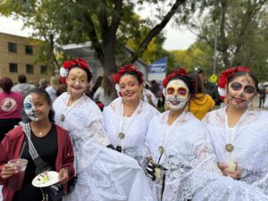 Miti next to ladies wearing white.