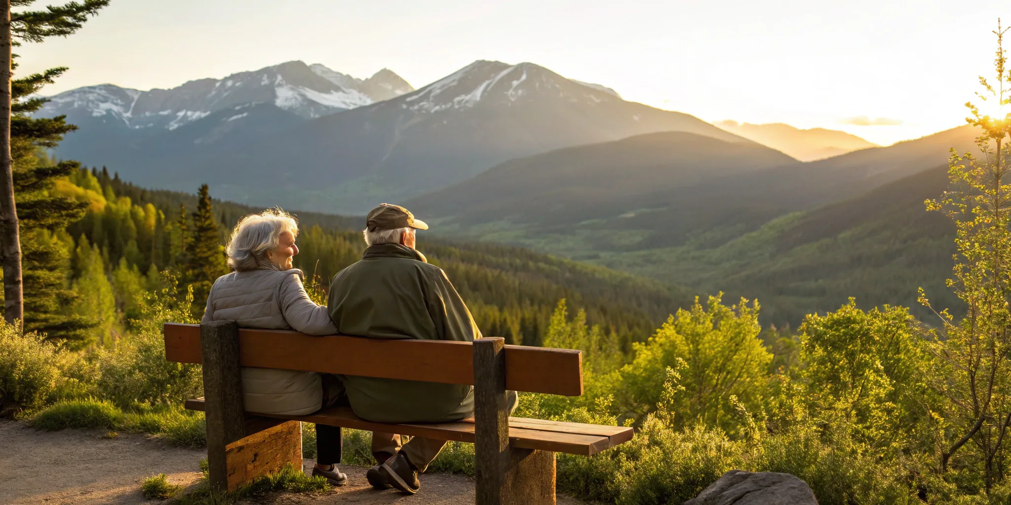A Colorado Medicare insurance agent discussing plan options with a senior couple in the mountains.