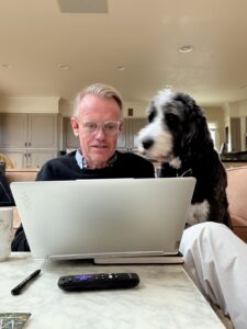 Karl working at his computer as Plato watches.