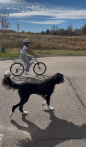 Miti riding a bike with Plato.