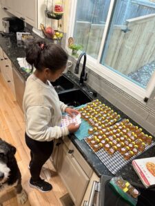 Miti putting labels on the honey bear containers.