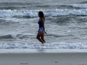 Miti walking in the ocean.