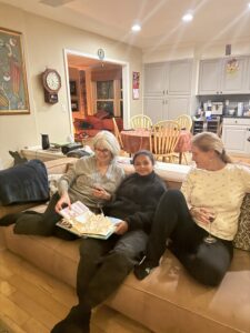 Three ladies sitting on a couch. 