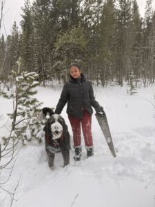 Miti holding a saw and standing next to Plato.