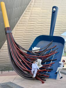 Karl and Miti on jumbo size broom and dust pan.