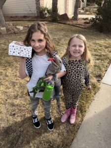 Two very cute girls delivering cookies.