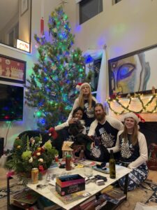 The Bruns-Kyler Family in front of the Christmas tree.