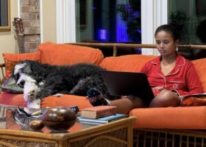 Miti and Plato sitting on an orange couch.