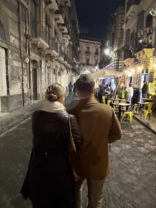 A couple walking down the street, possibly thinking about Medicare insurance.