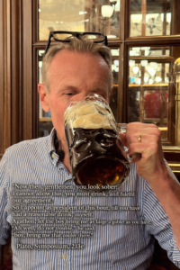 Karl drinking a small glass of beer.